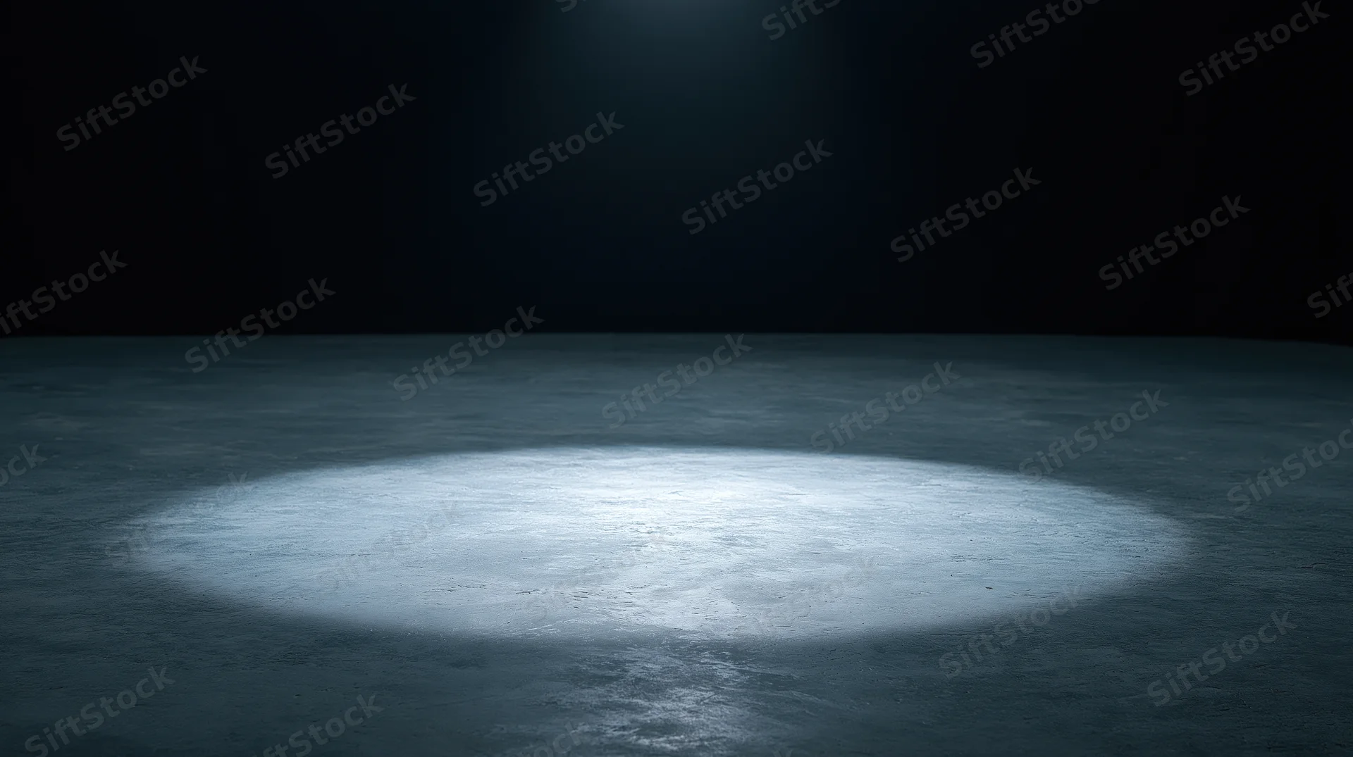 Spotlight beam on empty concrete floor in dark theater stage