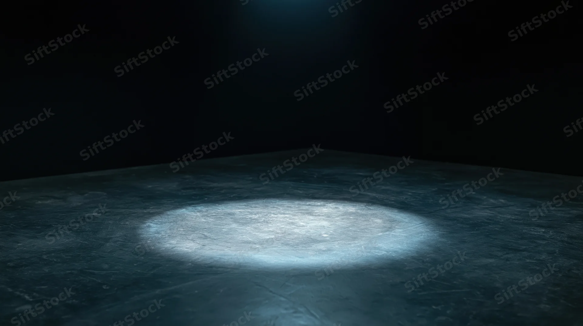 Spotlight beam on dark concrete floor in empty stage setting