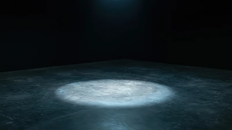 Spotlight beam on dark concrete floor in empty stage setting