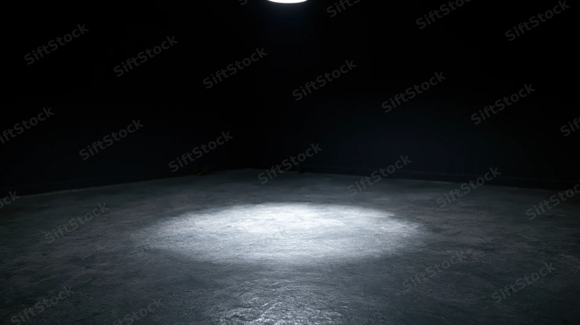 Spotlight beam on concrete floor in dark empty room