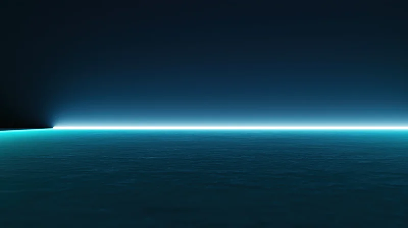 Calm ocean surface under dark sky with glowing horizon line