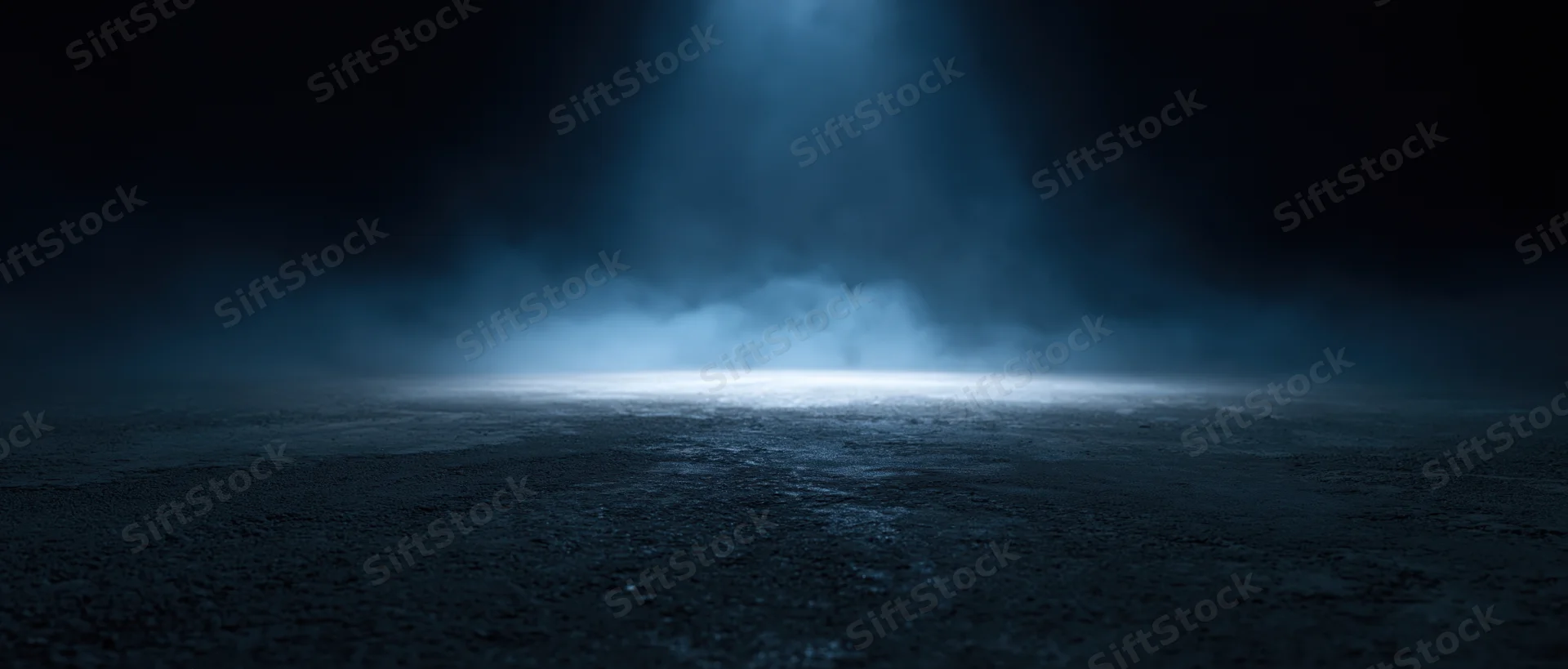 Spotlight beam illuminating a smoky dark stage floor at night