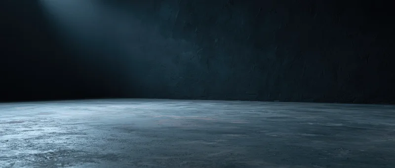 Dark empty industrial room with concrete floor and textured wall under dim blue lighting