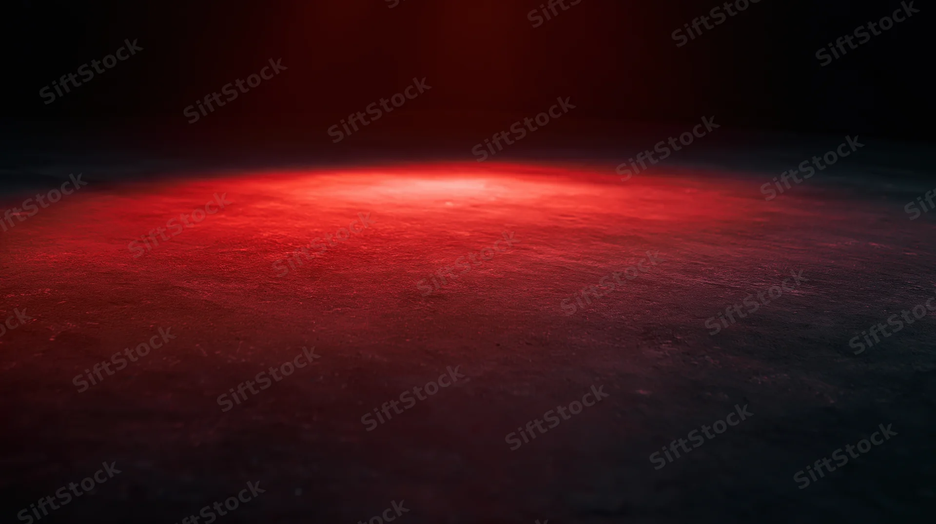 Red glowing light on dark textured surface with ambient illumination and shadowed edges
