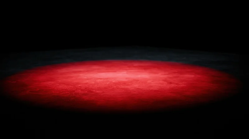 Red spotlight illuminating a dark stage floor
