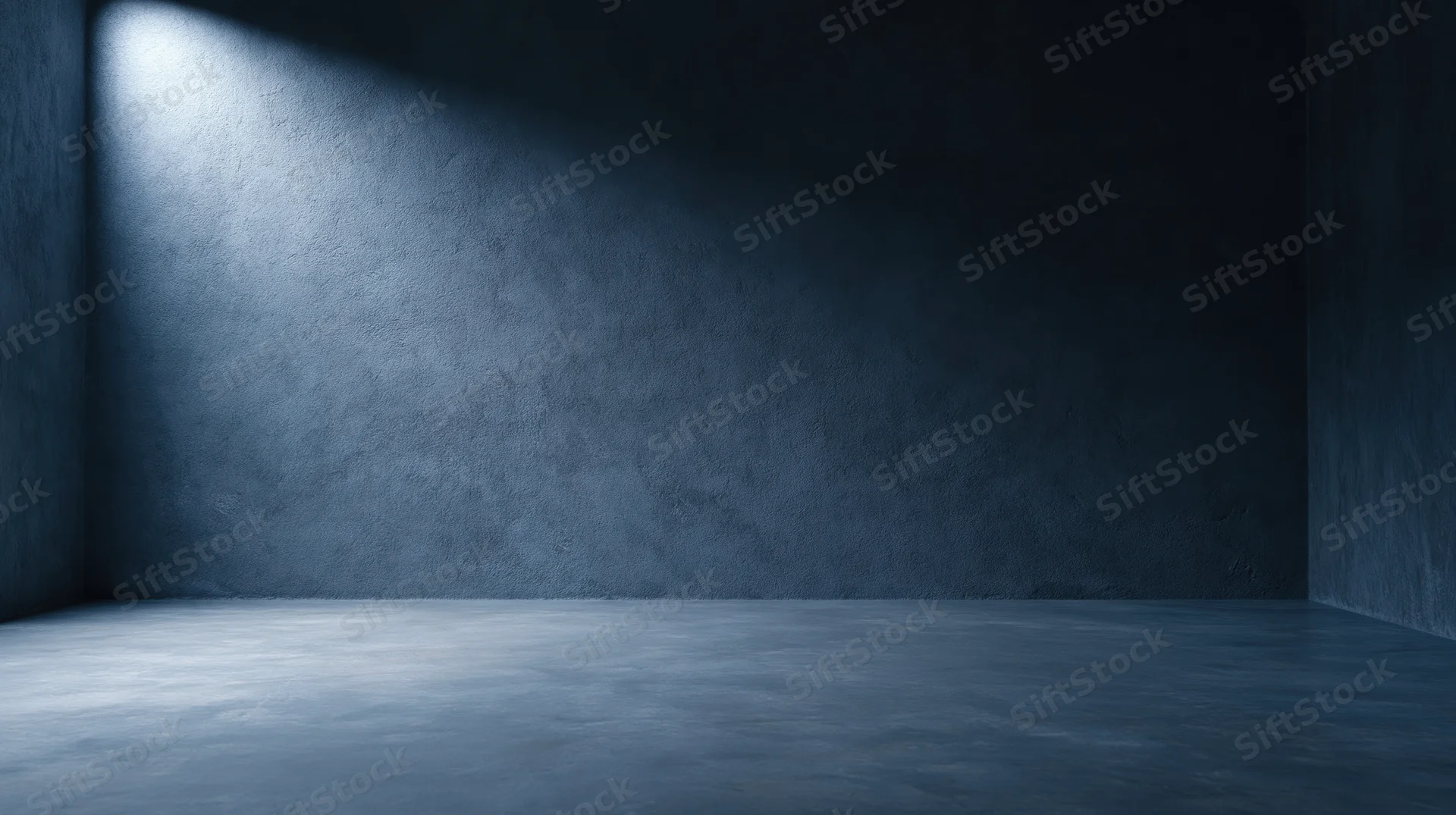 Empty concrete room with spotlight casting shadow on textured wall and floor
