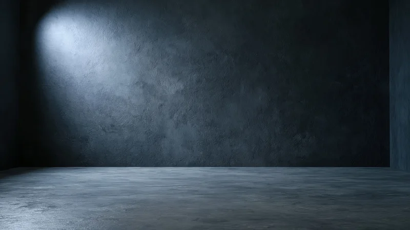 Empty industrial concrete room with spotlight on textured wall and floor