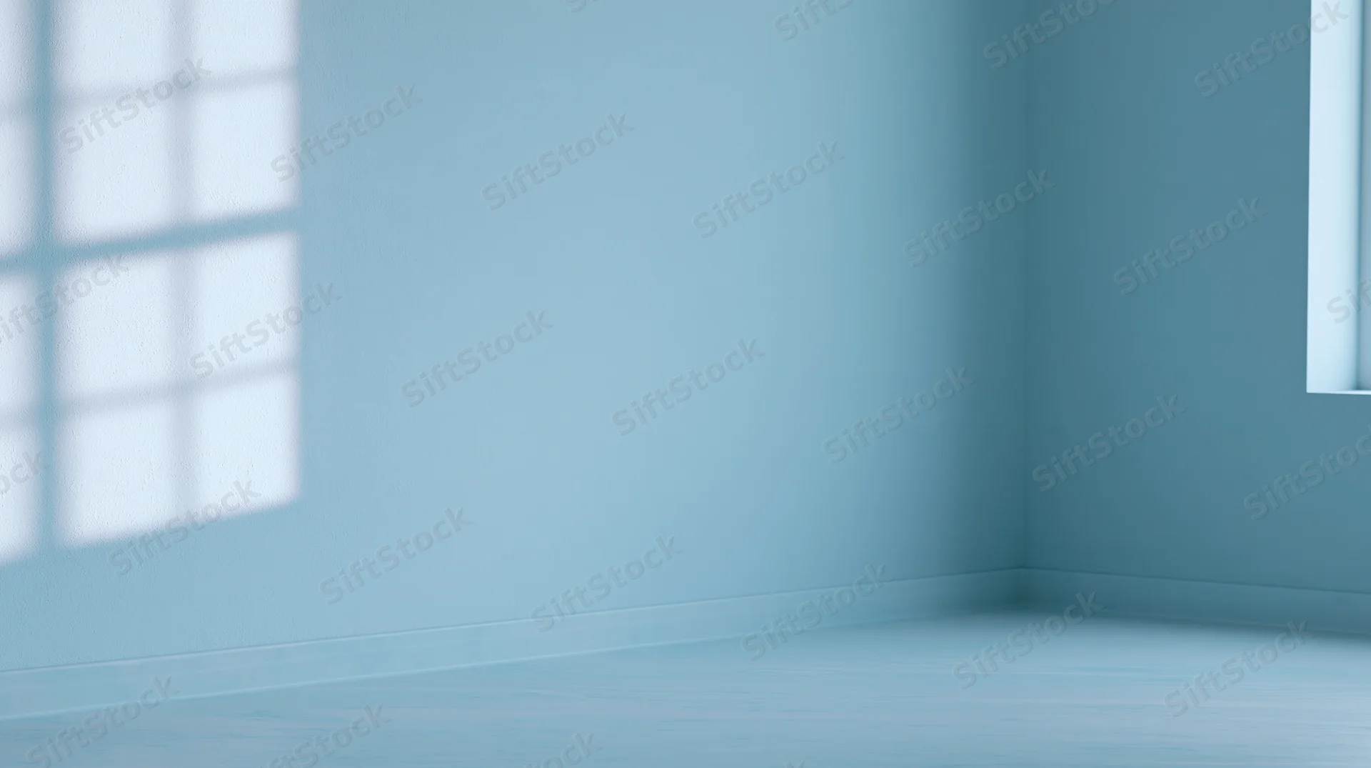 Empty blue room corner with window light and shadow on walls and floor