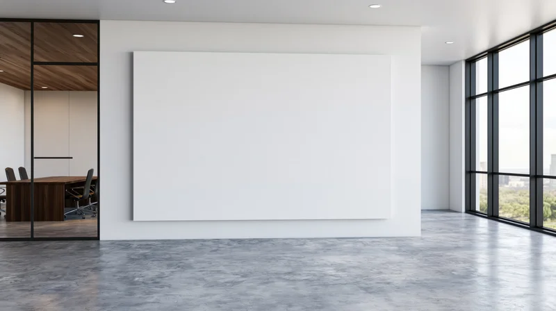 Blank white canvas on a wall in a modern office interior with large windows overlooking a city view