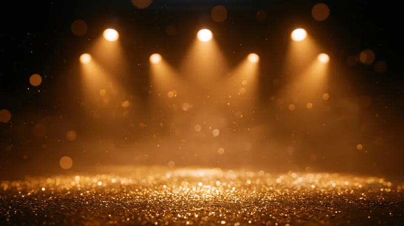Golden glittering stage floor illuminated by warm spotlights under hazy ambiance