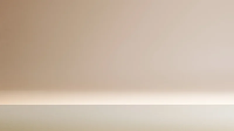 Smooth beige gradient background with soft light and copyspace for design placement