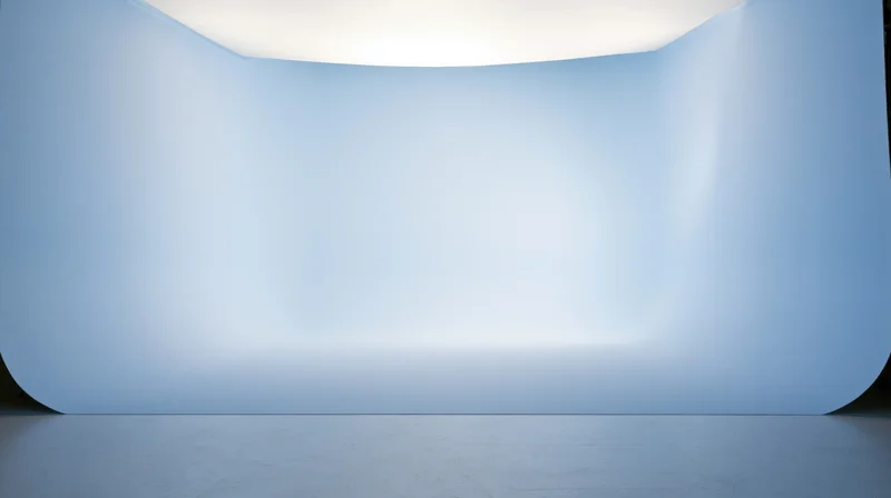 Curved blue gradient backdrop in a studio space with smooth surface and soft lighting