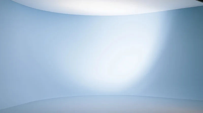 Curved blue gradient studio background with soft lighting and copyspace