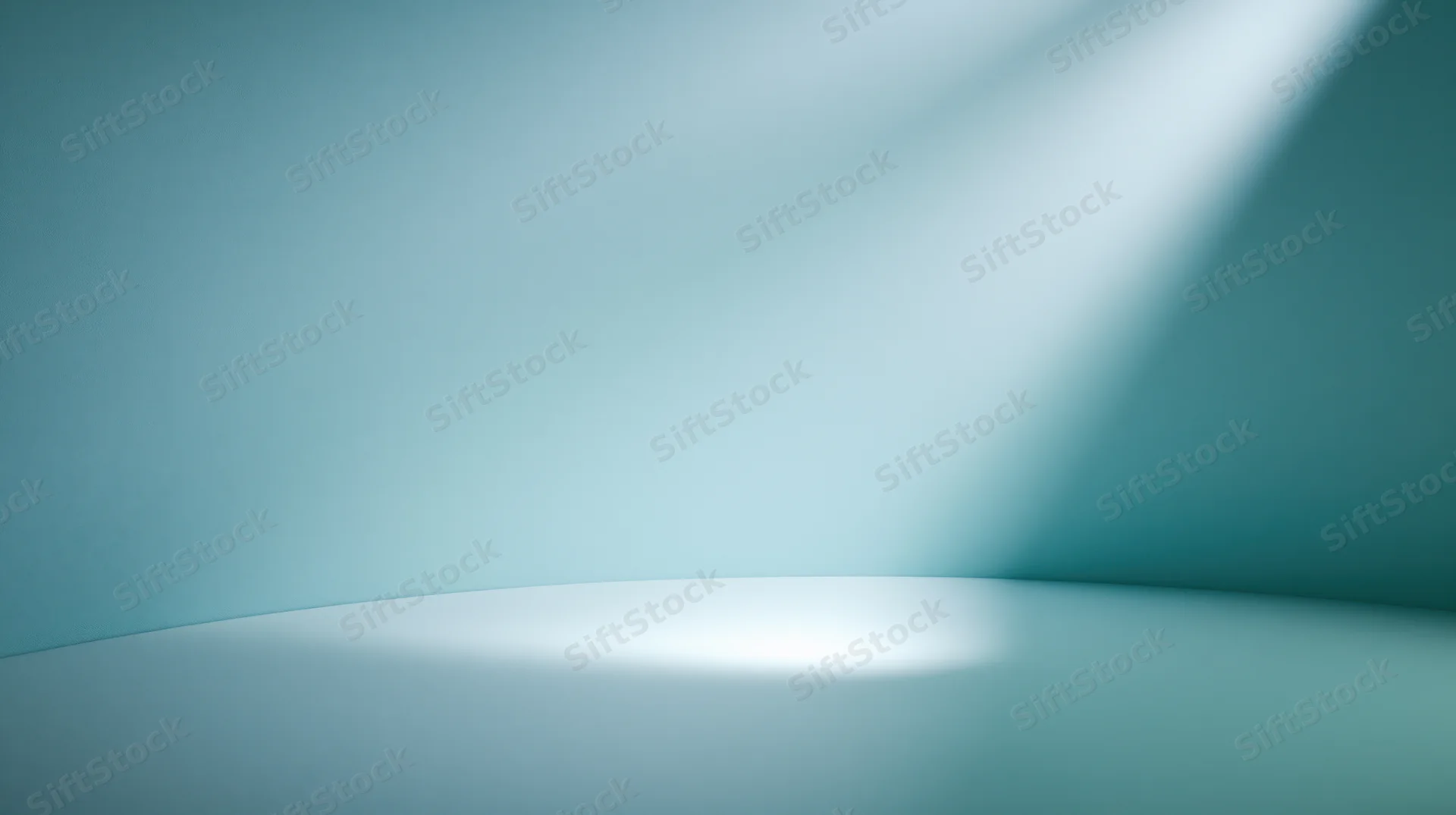A curved blue studio space with soft spotlight lighting and empty copyspace for product display