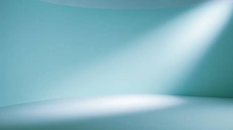 Curved blue studio space with spotlight illumination and copyspace