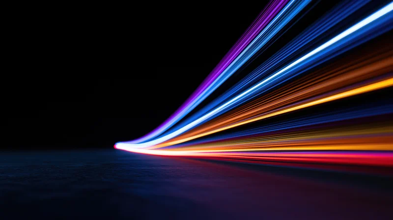 Colorful light streaks from moving vehicles at night on a dark road surface