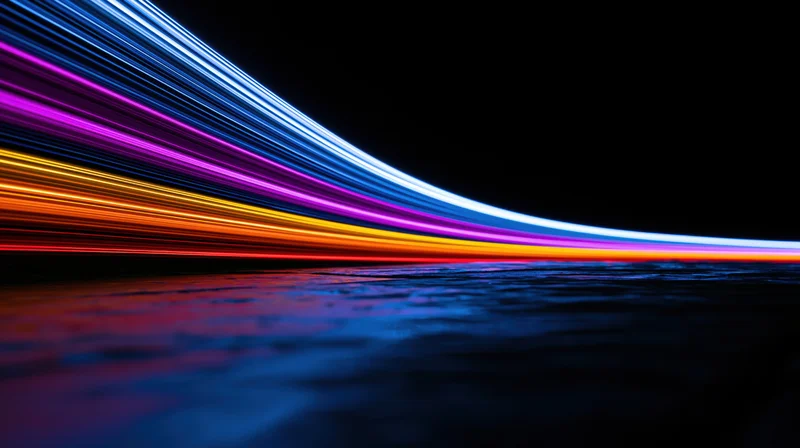 Colorful light trails curving over dark water surface at night