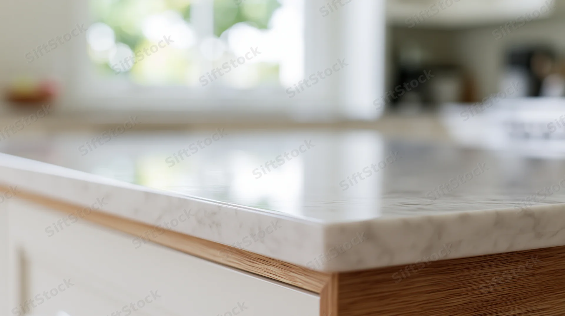 Close-up of a white marble countertop with wood edge in a modern kitchen interior
