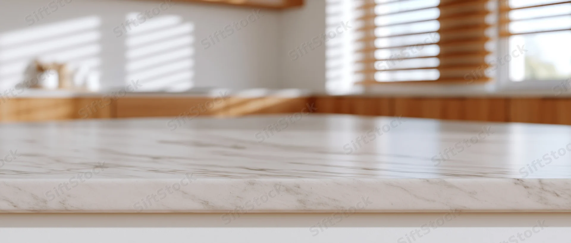 White marble countertop in modern kitchen interior with sunlight through wooden blinds