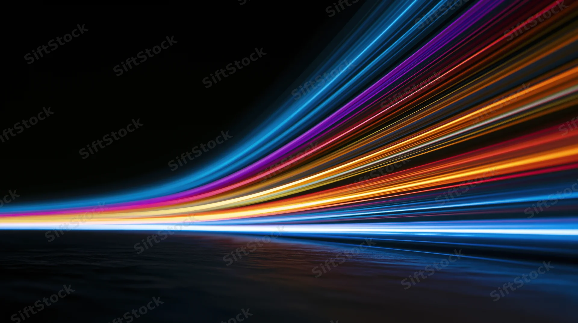 Colorful light streaks moving across dark background in dynamic motion