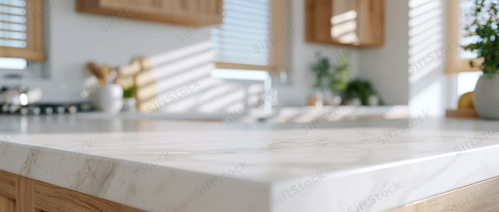 Marble countertop in a modern kitchen with wooden cabinets and natural light through blinds