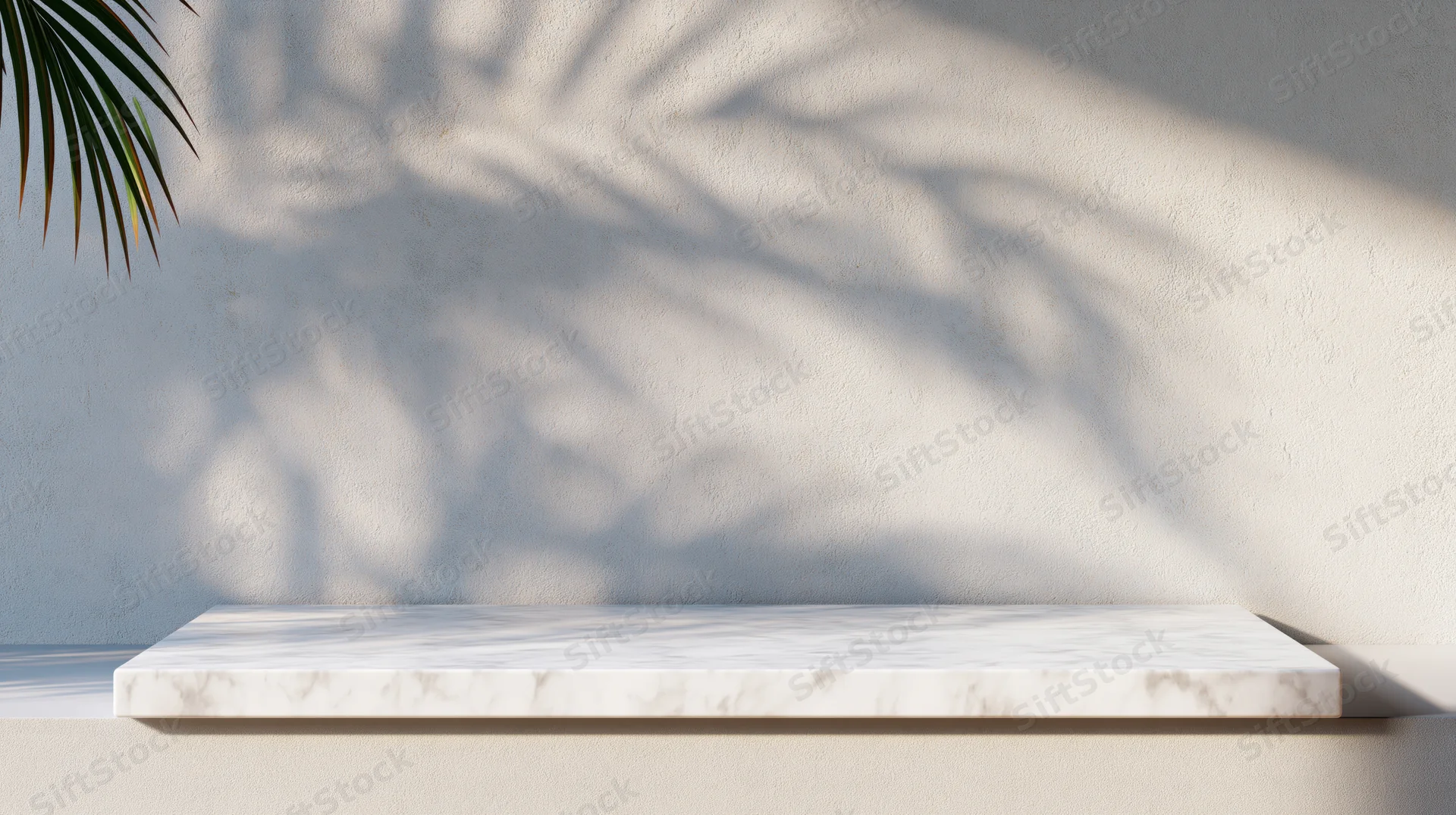 White marble shelf against textured wall with palm leaf shadow in bright sunlight