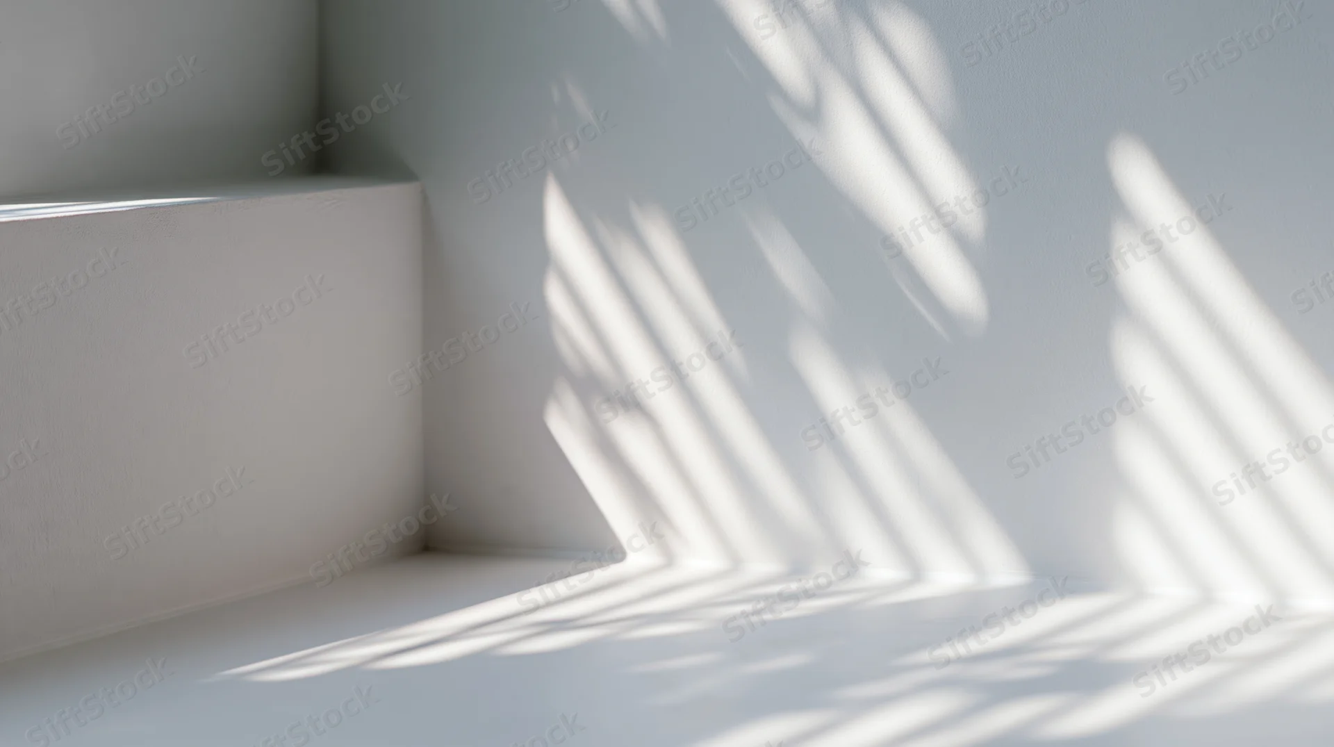 Sunlight casting striped shadows on white interior walls and floor in a corner space