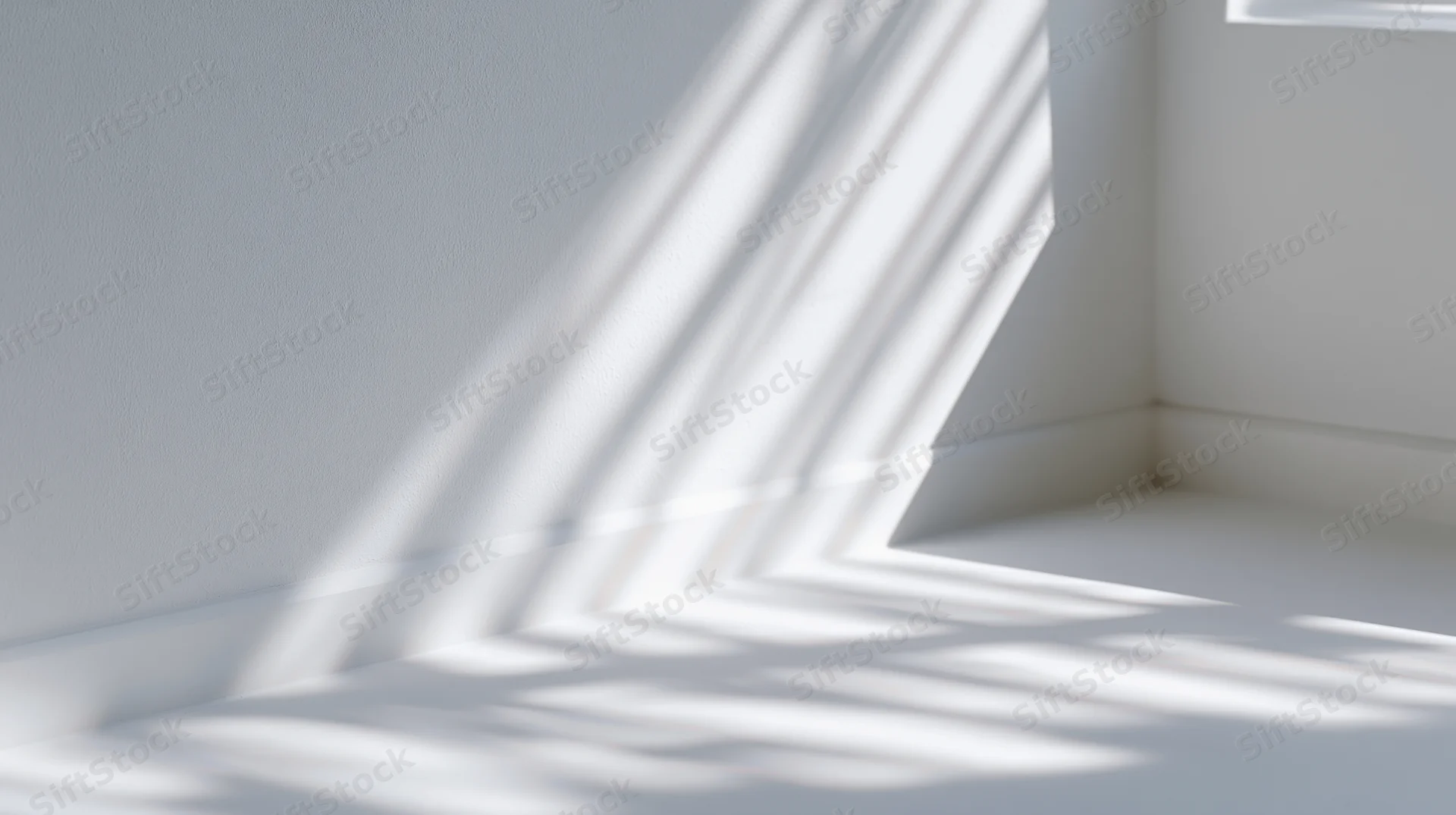 Sunlight casting striped shadows across white interior corner floor and wall