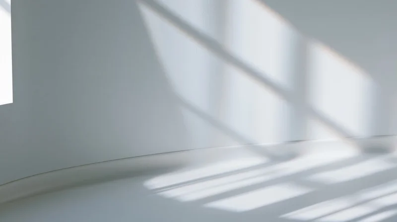 Light and shadow patterns on a white interior wall and floor