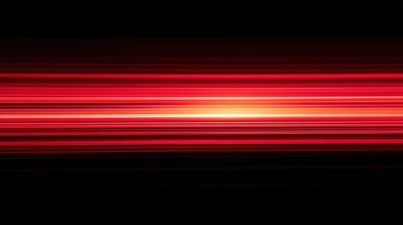 Horizontal red light streaks glowing against a black background with motion blur effect