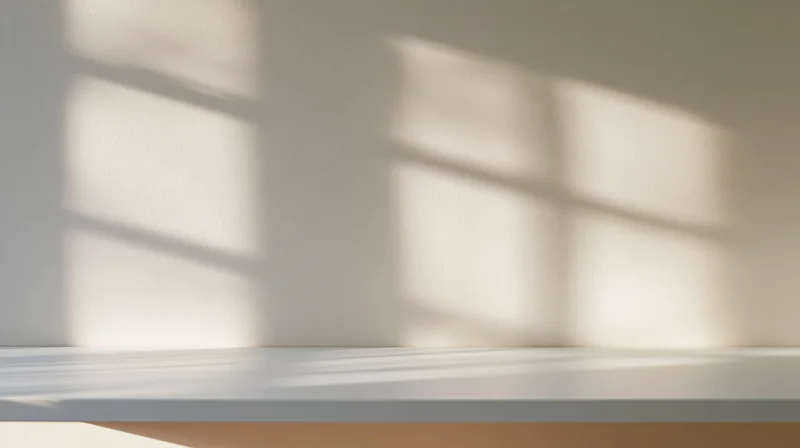 White shelf with window shadow in minimalist interior