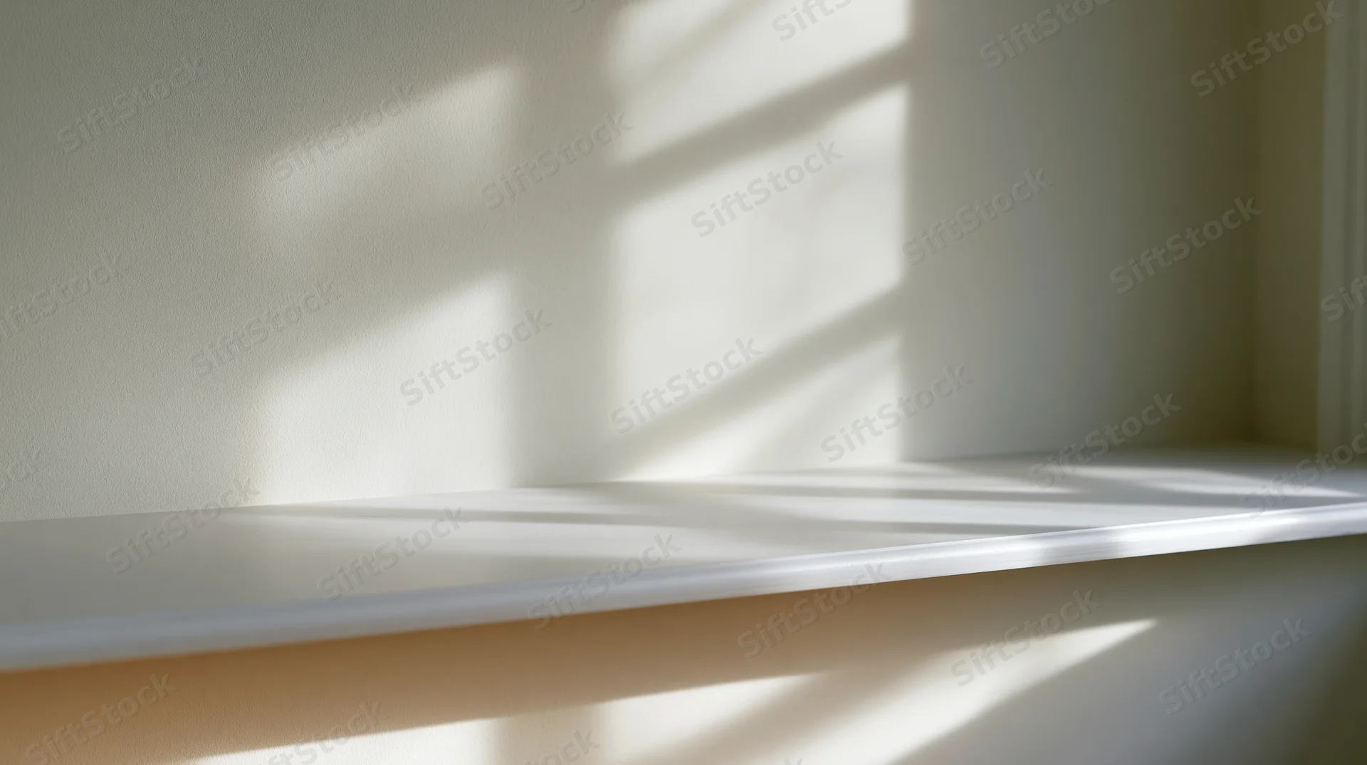 Empty white shelf in a sunlit room corner with striped shadows from blinds