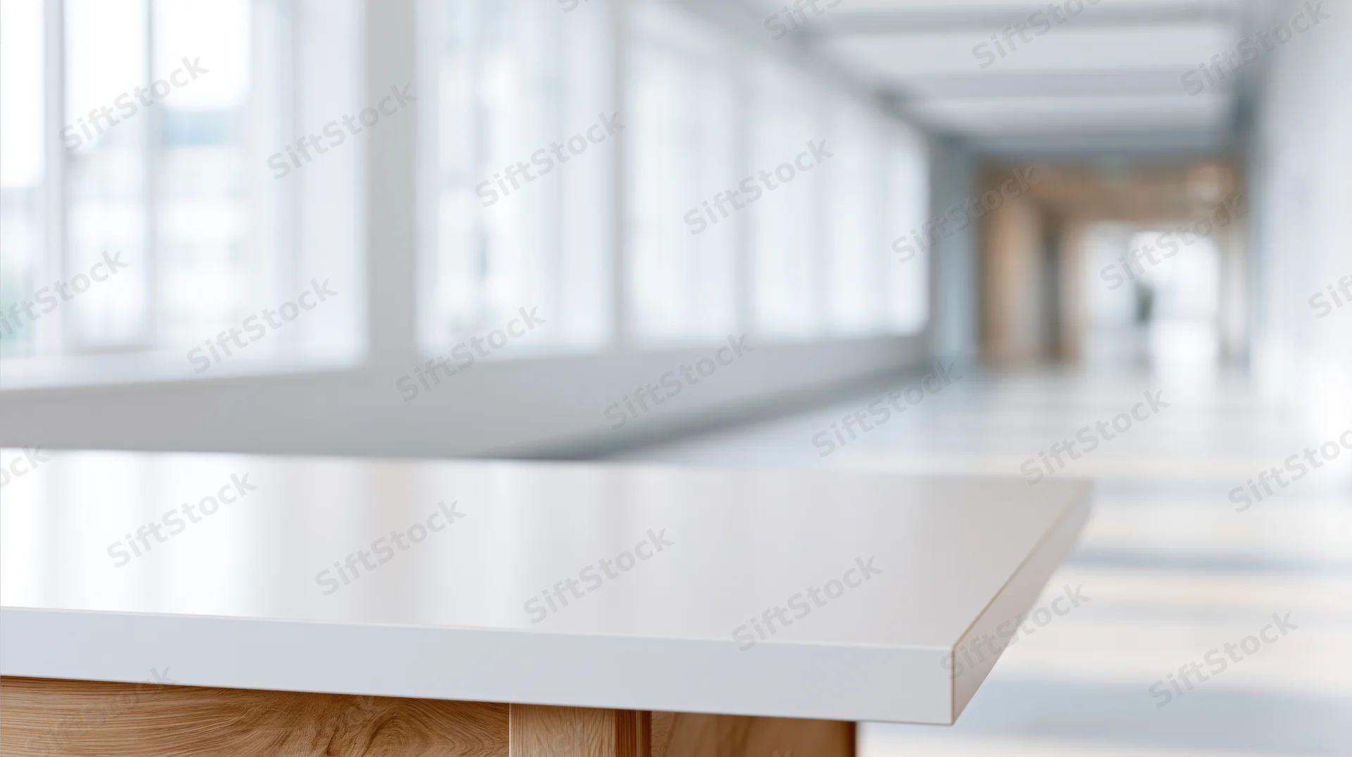 White table with wooden base in a bright modern office hallway