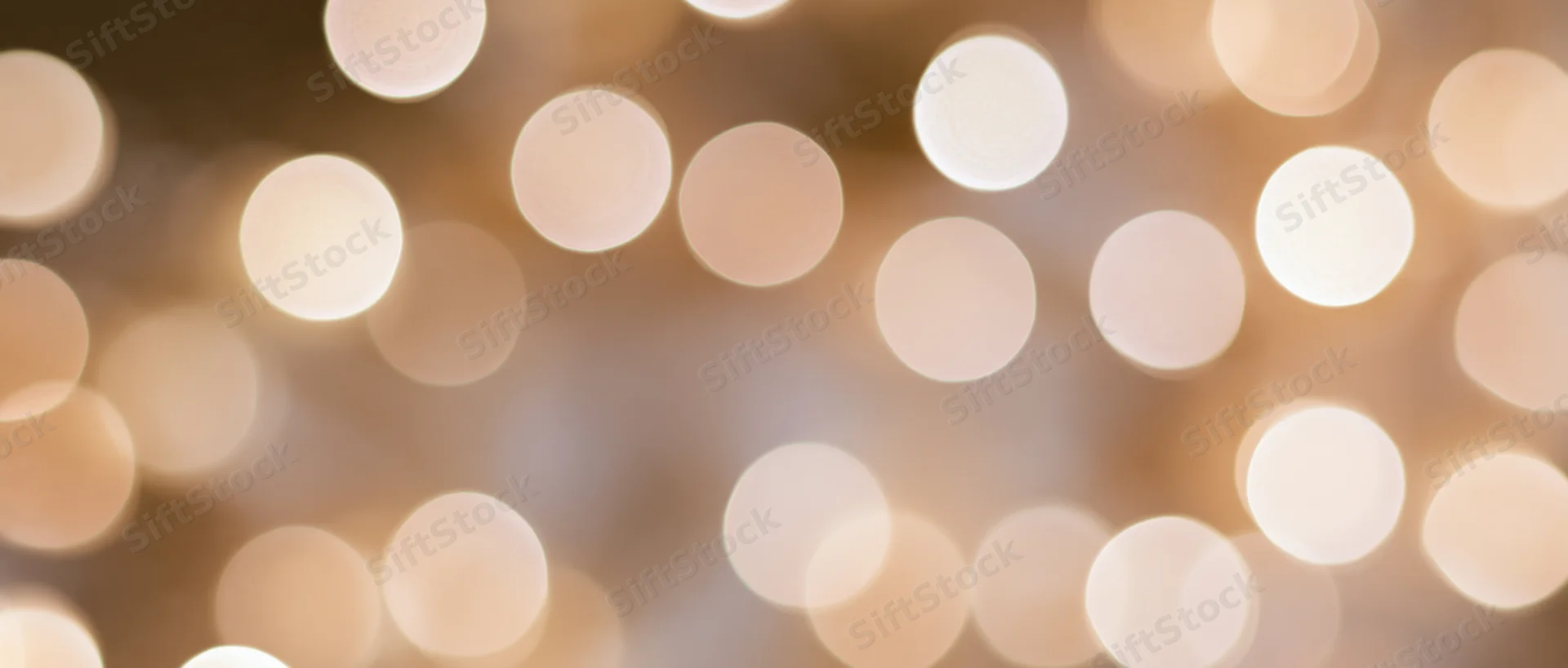 Warm bokeh lights arranged in soft circular patterns across a blurred background