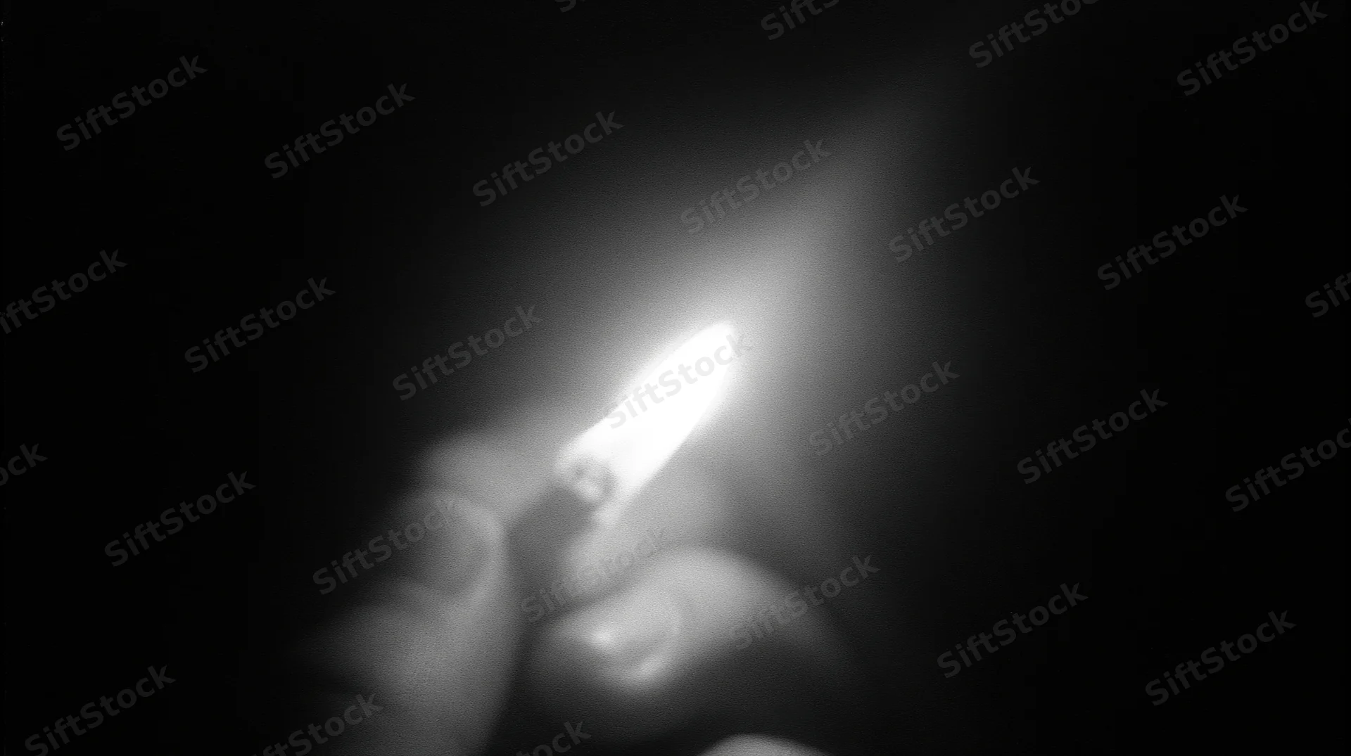 Hand holding lit lighter in darkness