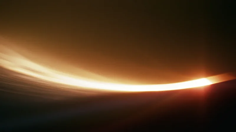 Curved horizon glowing with sunrise light against dark sky