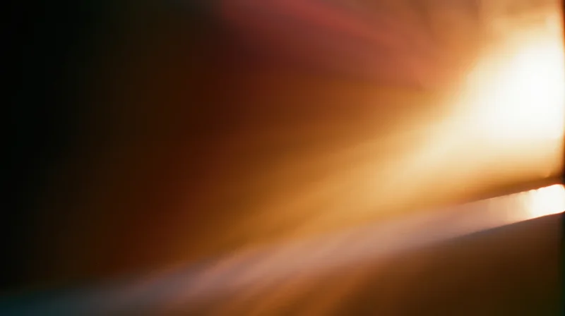 Radiant light beams glowing across a blurred horizon at sunrise or sunset