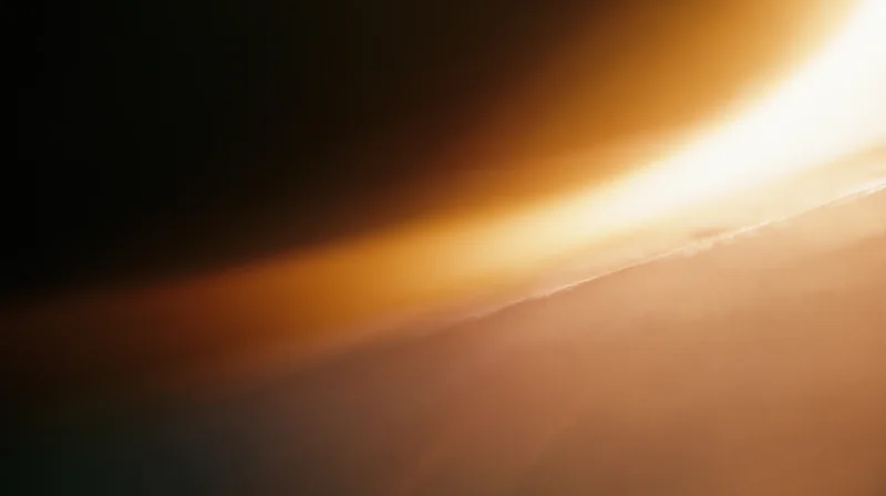 Warm glowing light radiating across a soft gradient sky at sunrise or sunset