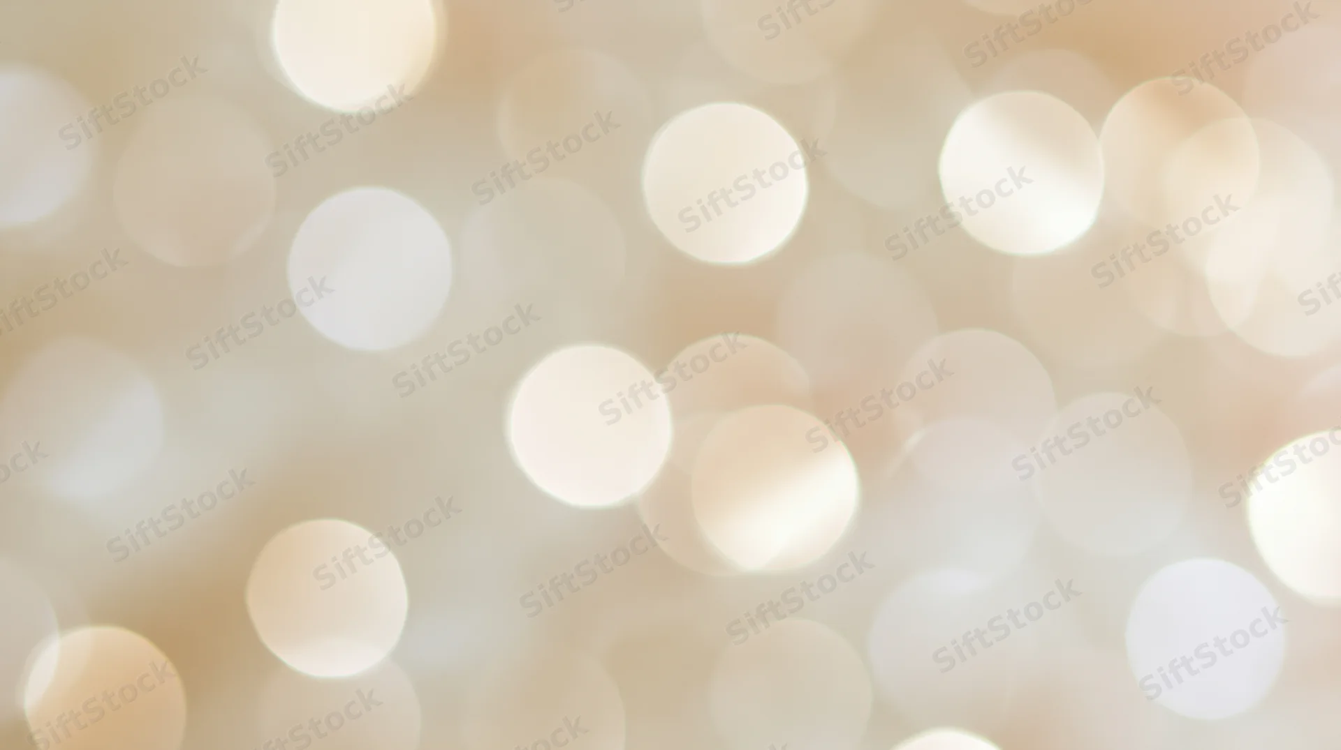 Soft glowing bokeh lights in warm beige and white tones filling the frame as a decorative background