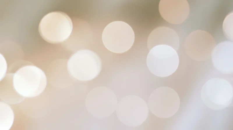Blurred circular lights creating a soft glowing background with warm tones and festive ambiance