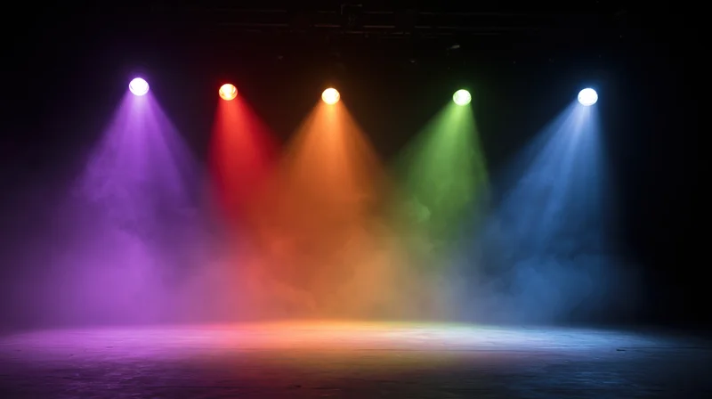Five colored spotlights shining down on a smoky stage floor