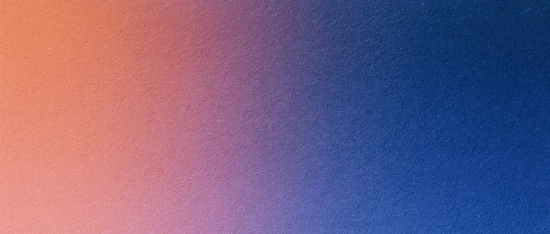 Smooth color gradient transitioning from orange to blue across a textured surface