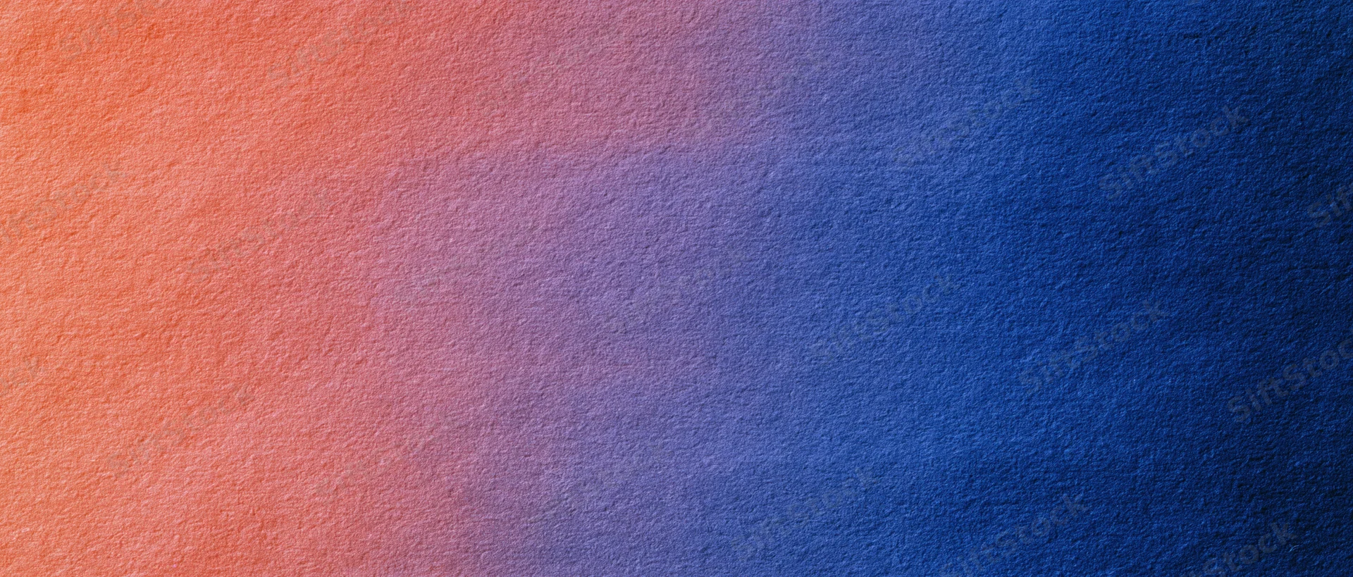 A smooth color gradient transitioning from orange to blue across a textured surface