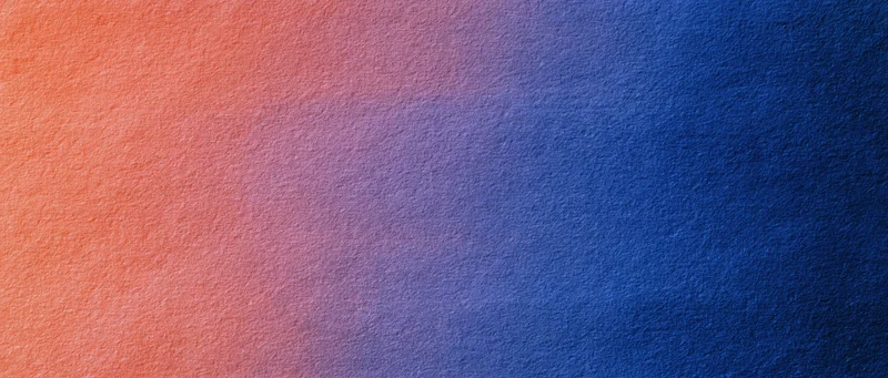 A smooth color gradient transitioning from orange to blue across a textured surface