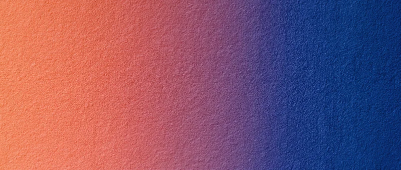 Smooth color gradient transitioning from orange to blue across a textured surface