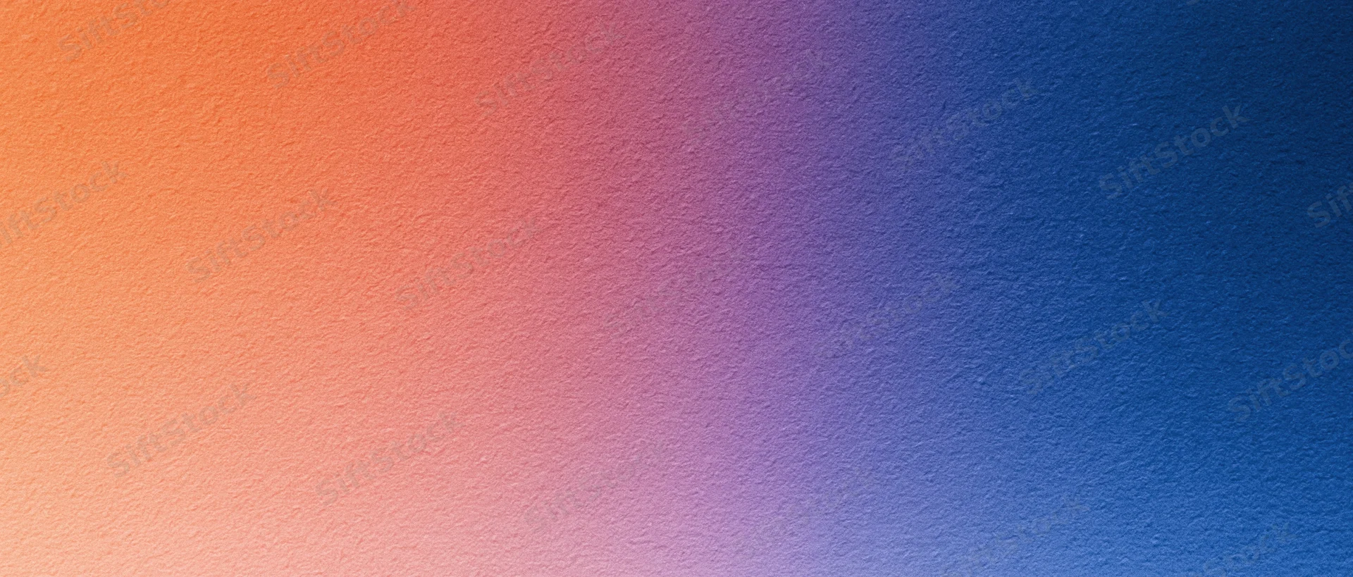 Smooth color gradient transitioning from orange to blue across a textured surface