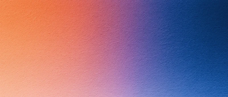 Smooth color gradient transitioning from orange to blue across a textured surface