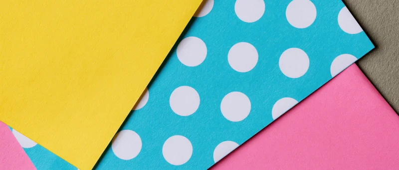 Colorful patterned paper sheets overlapping in flat lay arrangement