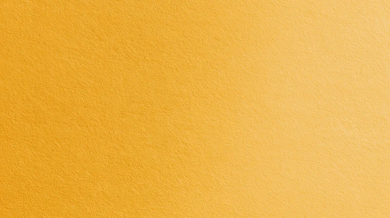 A solid yellow textured surface filling the frame as a uniform background
