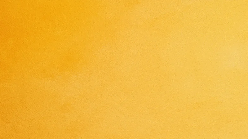 A solid yellow textured surface filling the frame as a background